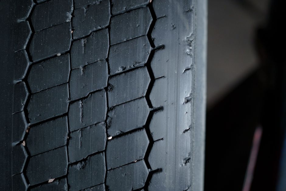 Mechanic inspecting tire tread depth